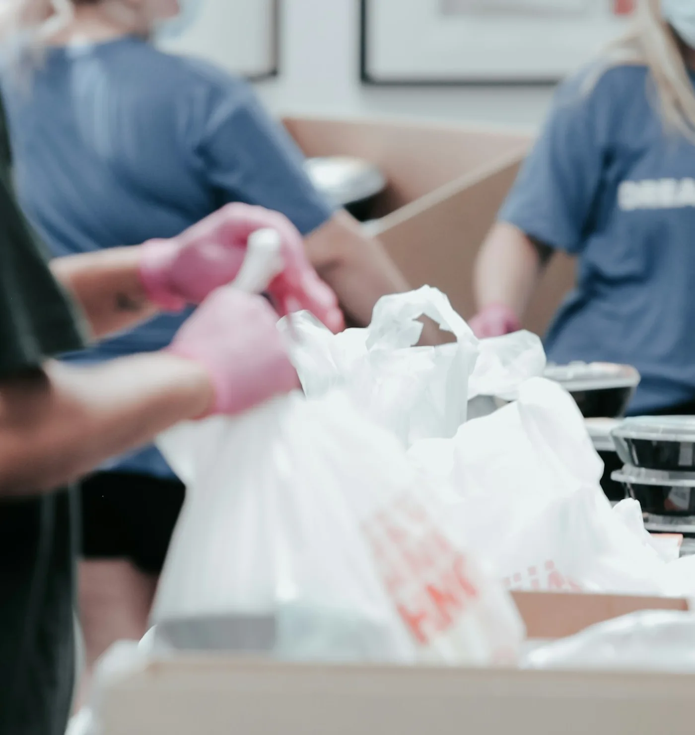 Volunteers working together to pack food for distribution; illustrative photograph
