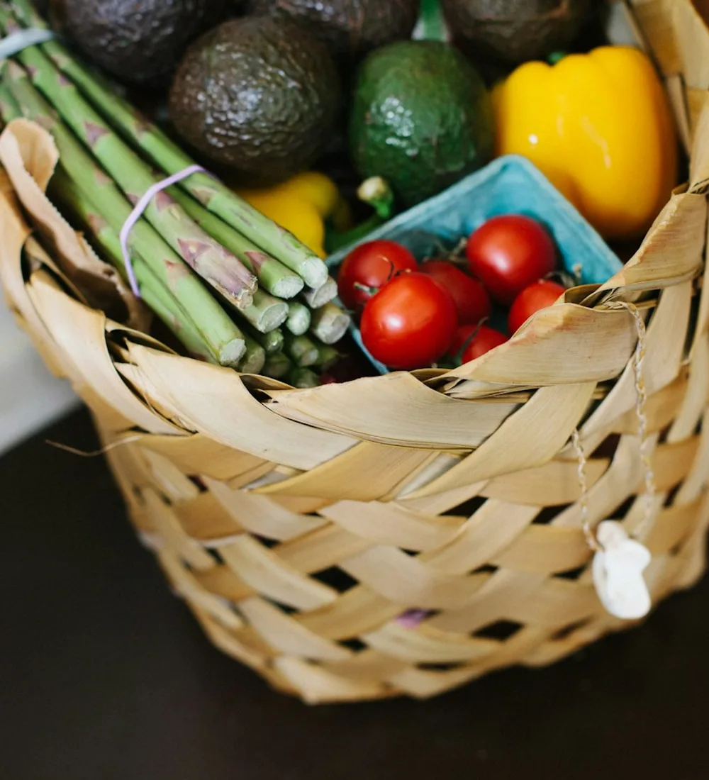 A basket filled with fresh vegetables, illustrating everyday food essentials
